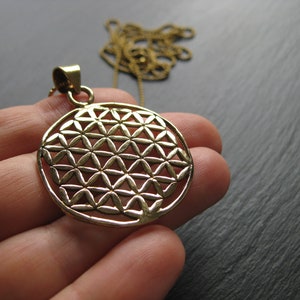 Solid brass Flower of Life round pendant with textured sacred geometry on chain