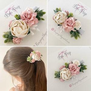 Girls flower hair clip with ivory and blush pink blooms and green leaves, floral cluster