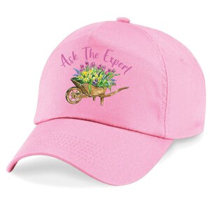 Pink gardening baseball cap with embroidered 'Ask The Expert' and wheelbarrow flower graphic
