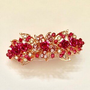 Pink floral crystal hair clip with rose-gold barrette and red gem detailing