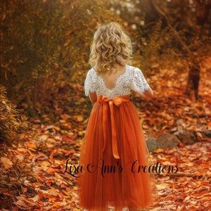 Girls orange tulle flower girl dress with lace sleeves and bow