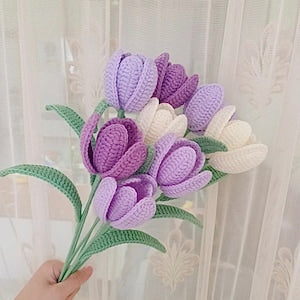 Handmade crochet tulip bouquet with purple and cream petals, green stems and leaves