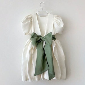 Toddler ivory linen flower girl dress with puff sleeves and green sash bow