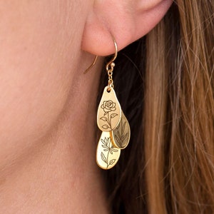 Gold-tone dangle earrings with engraved floral leaf design and slim hoop drop