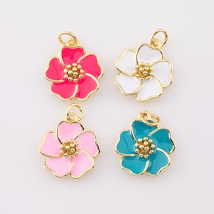 Gold-tone enamel hibiscus flower charms with pink and teal petals, bead center, loops