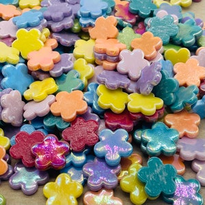 Iridescent ceramic flower tiles in assorted pastel colors, glossy flat pieces