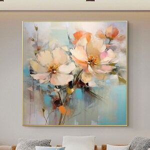 Abstract floral oil painting on canvas with pastel peach and pink blooms in a gold frame
