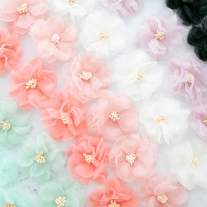Small organza fabric wildflowers, pink and white layered petals with tiny yellow stamens