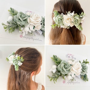 Sage green and ivory/white floral hair clip with greenery leaves on a silver clasp