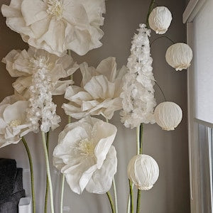 White flower wall hanging with layered fabric petals and hanging round blooms