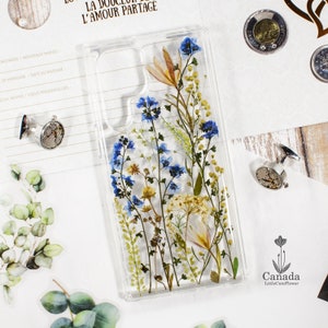 Pressed flower phone case cover with blue and yellow botanical design, clear backing