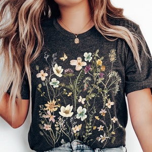 Black botanical t-shirt with pressed flowers graphic across the chest