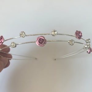 Pink floral headband with rose charms and rhinestone accents on metal band
