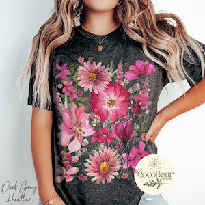 Floral graphic t-shirt with dark base and bright pink wildflower print, short sleeves