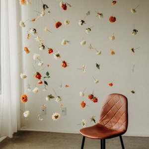 Hanging flower garland with small white, orange, and red blooms