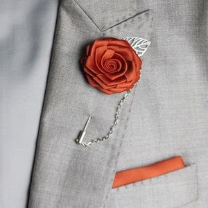 Rust orange fabric rose lapel pin with chain and matching pocket square