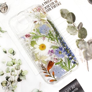 Pressed-flower phone case cover with clear background and mixed green, purple, yellow florals