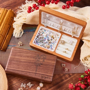 Wooden jewelry box, open with compartments and necklace hooks for rings and earrings