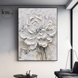 Framed 3D floral wall art with raised white flower and textured relief petals
