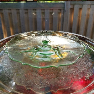 Vintage decorative glass plate with scalloped edge and green flower pattern