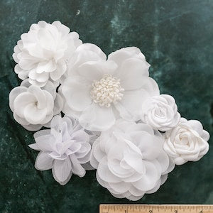 Assorted white fabric flowers cluster, layered petals with small rosette centers