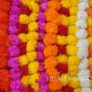 Artificial marigold flower garlands in yellow, orange, purple, and white for decoration