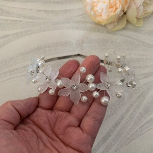 Silver pearl headband with clear flower accents and small pearl beads on a thin band