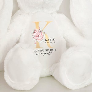 Personalized white plush teddy bear with embroidered name and flower girl proposal text.