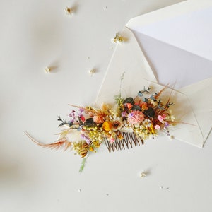 Floral hair comb with preserved wildflowers and small leaf accents, comb teeth visible