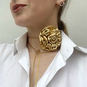 Gold rose flower choker necklace with metallic rose centerpiece and tie-back