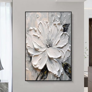 Framed 3D white floral wall art with raised petal texture and central bloom