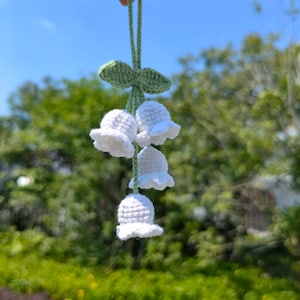 Crochet lily of the valley flower pattern with hanging white bells and green stem