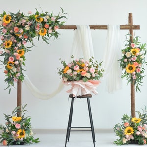 Wedding flower arch swag with sunflowers, roses, and eucalyptus greenery