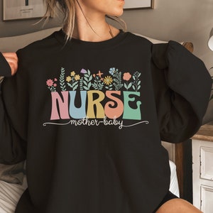 Black nurse sweatshirt with floral NURSE graphic and mother-baby text