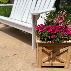 Farmhouse wooden planter box with pink flowers