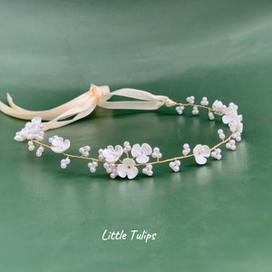 White pearl flower headband with small blossoms and ribbon ties for kids