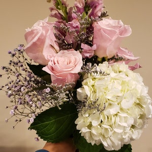 Fresh flower bouquet with pink roses, white blooms, and lavender sprigs