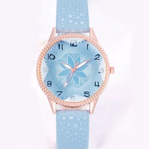 Blue flower quartz watch with light blue strap and rose-gold bezel, blue dial with floral design