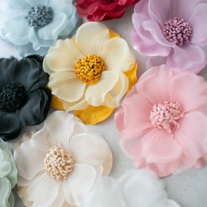 Pastel faux organza fabric flowers with layered petals, including blue, pink, yellow, white