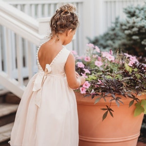 Ivory tulle flower girl dress with back bow detail, sleeveless A-line skirt