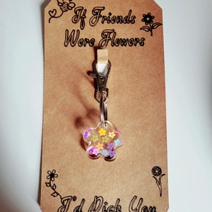 Flower-shaped keychain charm with pink and purple enamel, metal clip