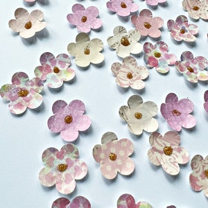 Paper flower confetti with pastel pink and cream blossoms and gold center details