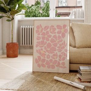 Pink floral art print with repeating petal shapes on a white background
