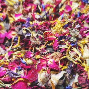 Colorful dried rose and flower petals scattered on a fabric surface
