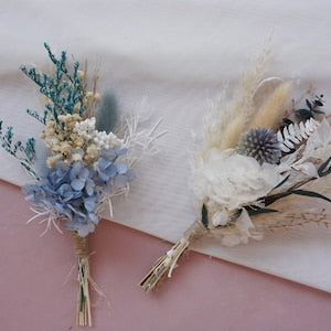 Mini dried flower bouquet set with light blue, white, and pinecone accents in tied stems