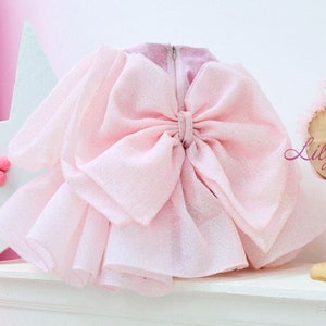 Light pink glitter tulle dress with oversized bow and puffy skirt