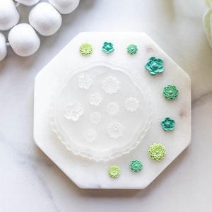 Silicone mini flower press mold with raised flower and petal pattern, hexagonal tray