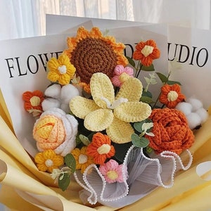 Crochet flower bouquet with orange, white, and pink blossoms and green leaves