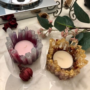 Resin tea light holders with crystal-like resin, one pink candle and one gold candle