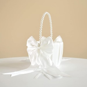 White satin flower basket with large bow and pearl beaded handle